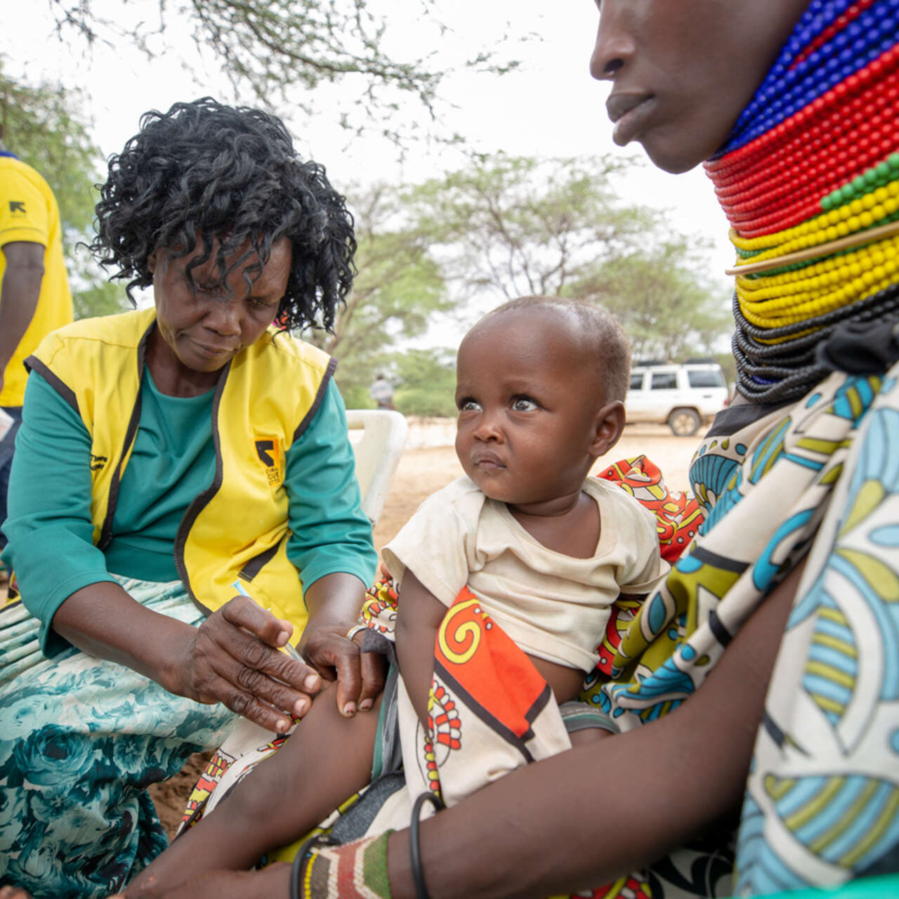 IRC Nurse, immunizing Selina Naoi’s* child, Maria* during IRC community outreach program.